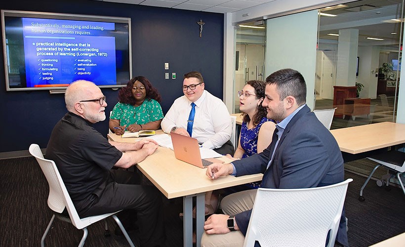 Professor and graduate students in classroom