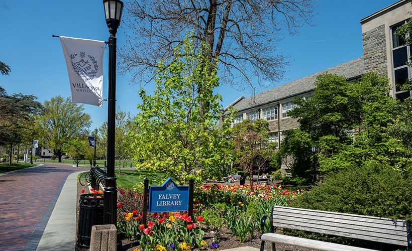 Sign and flowers outside Falvey Library