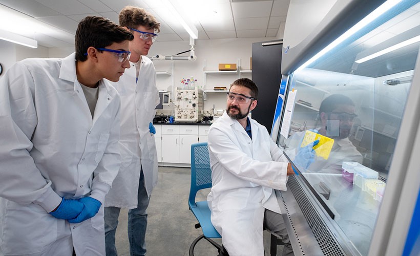 Professor and students in lab