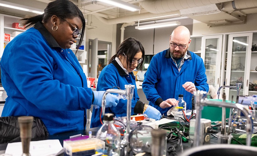Professor and students working in lab