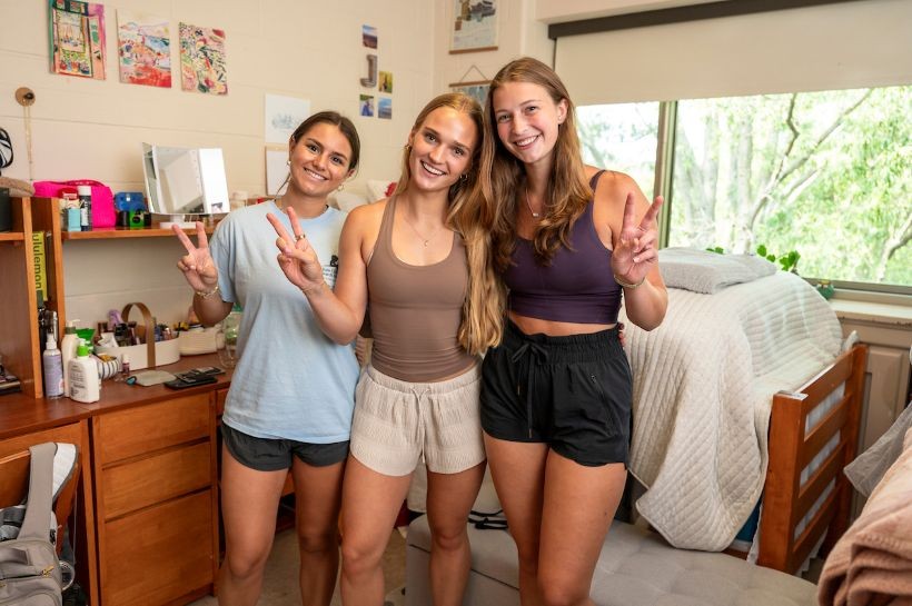 Three students in a first-year residence hall room