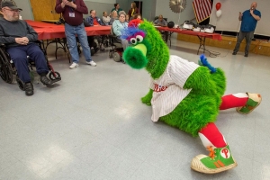 The Phillie Phanatic faces off a stand-in for the Detroit Tigers at the New Jersey Veterans Memorial Home at Vineland, N.J., April 11, 2018