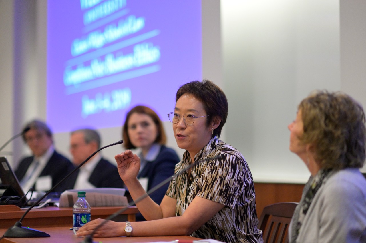 Hui Chen with panel in background ComplianceNet Panel