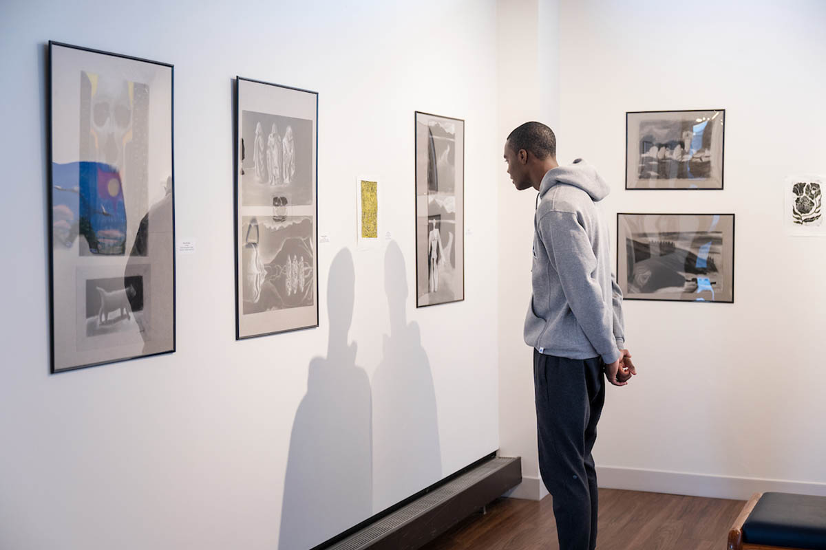 A student admiring art in a gallery