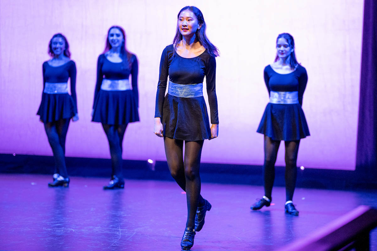Students doing traditional Irish dance on a stage