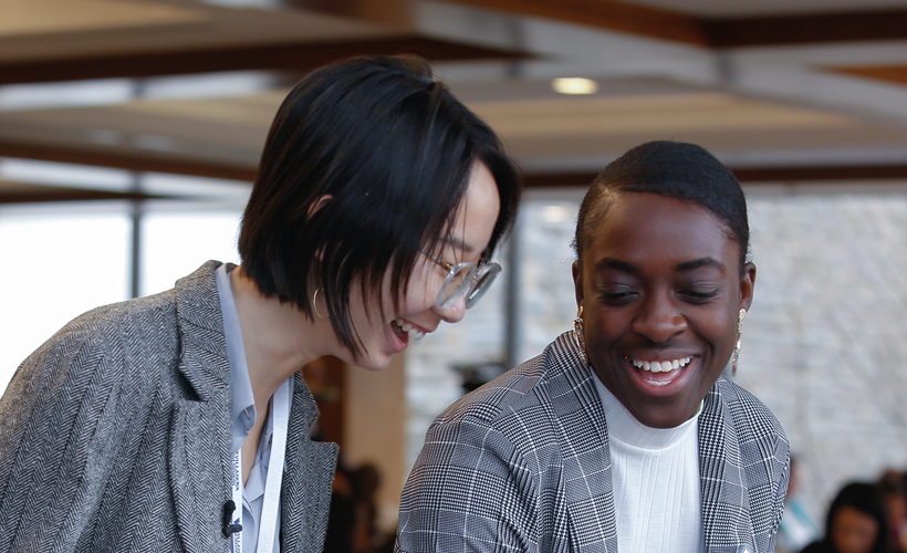 Two students laughing with each other