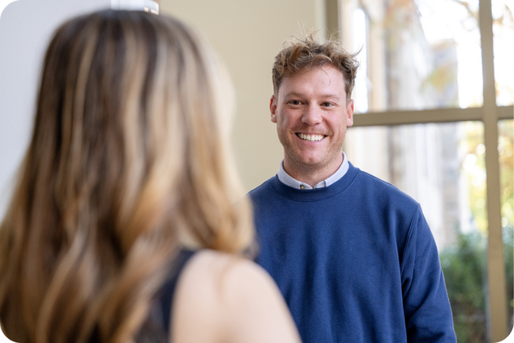 Man smiling at student