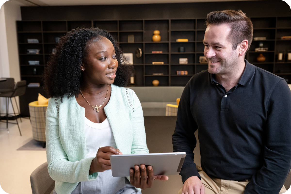 Two students talking over tablet