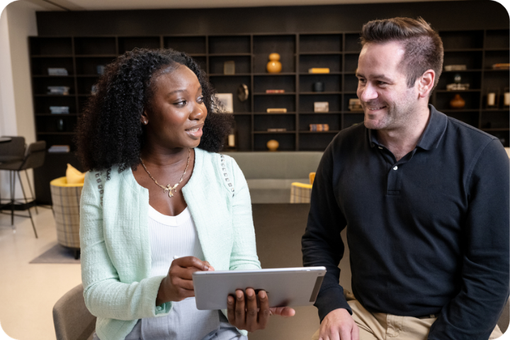 Two people talking over tablet
