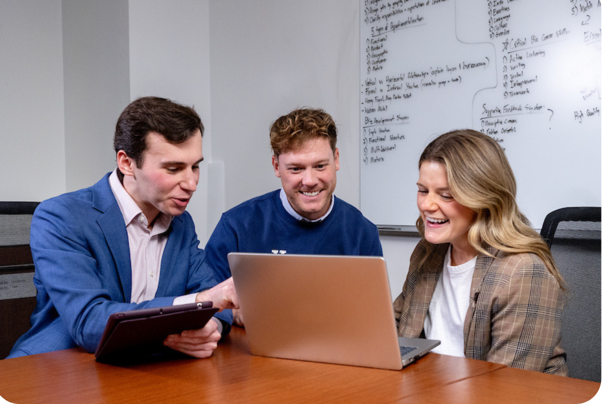 Three students in front of laptop