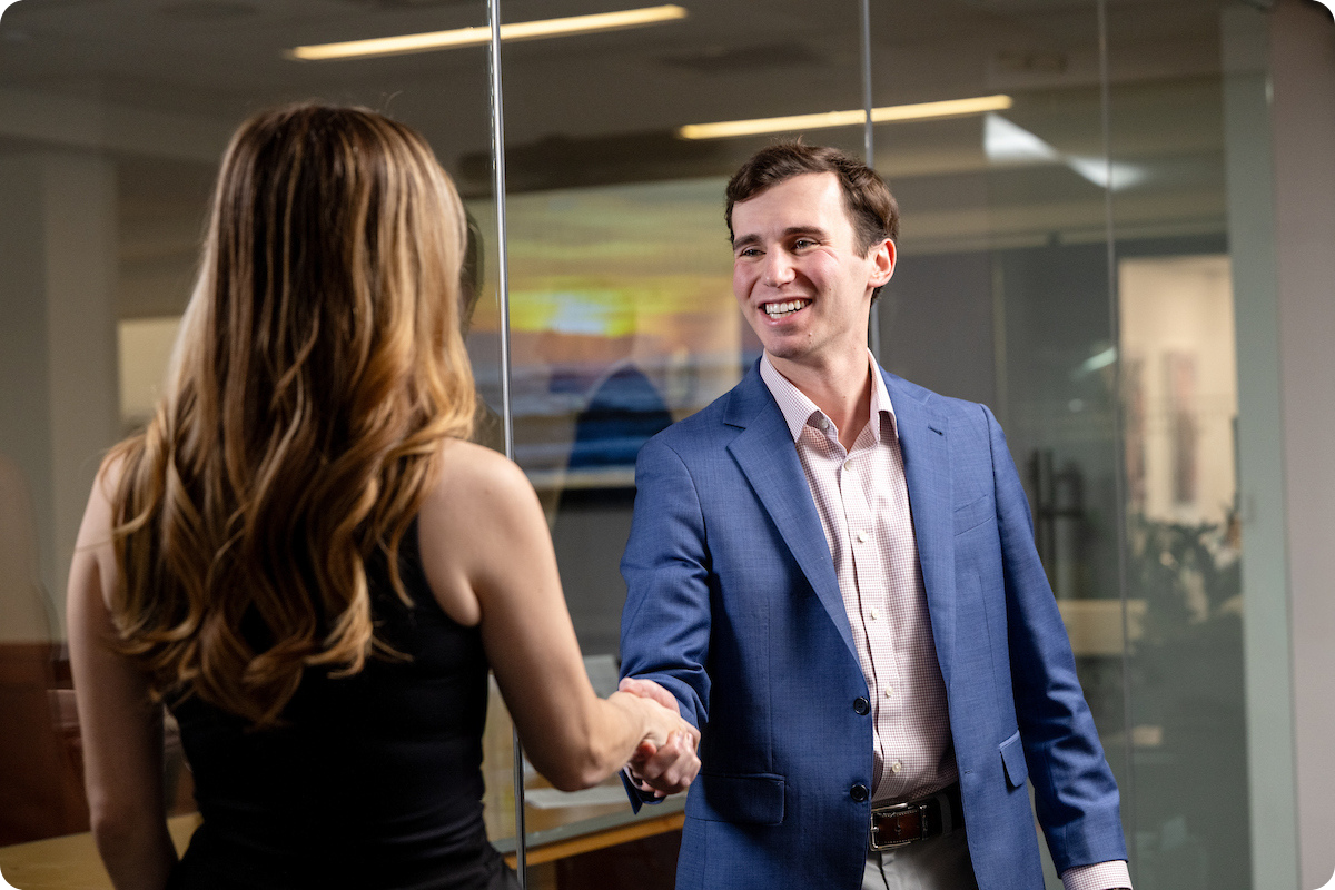Two students shaking hands