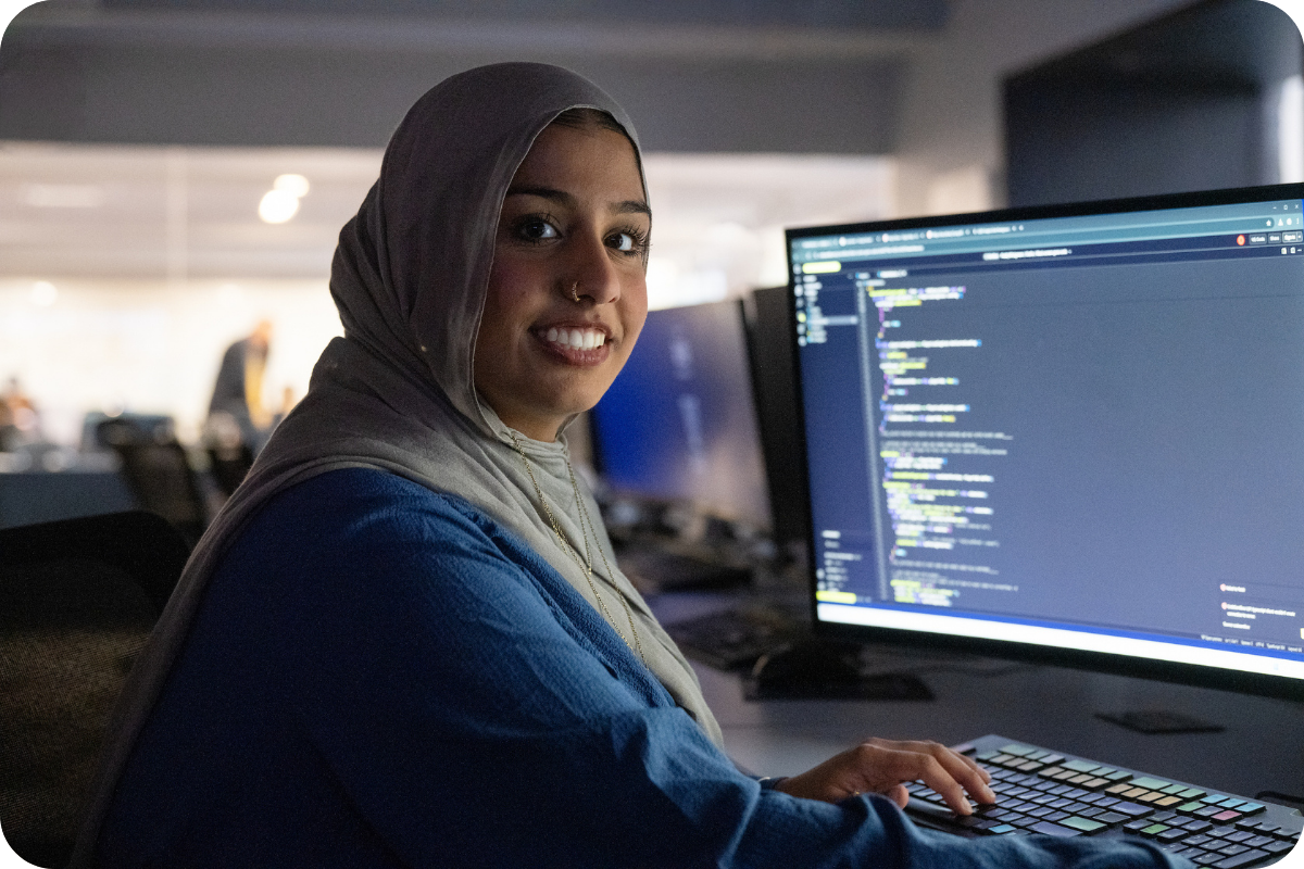 Student smiling at computer