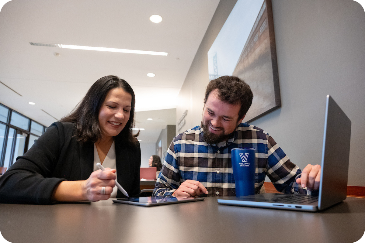 Two students on laptop