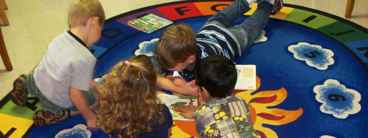 A child using a play stethoscope on a caretaker