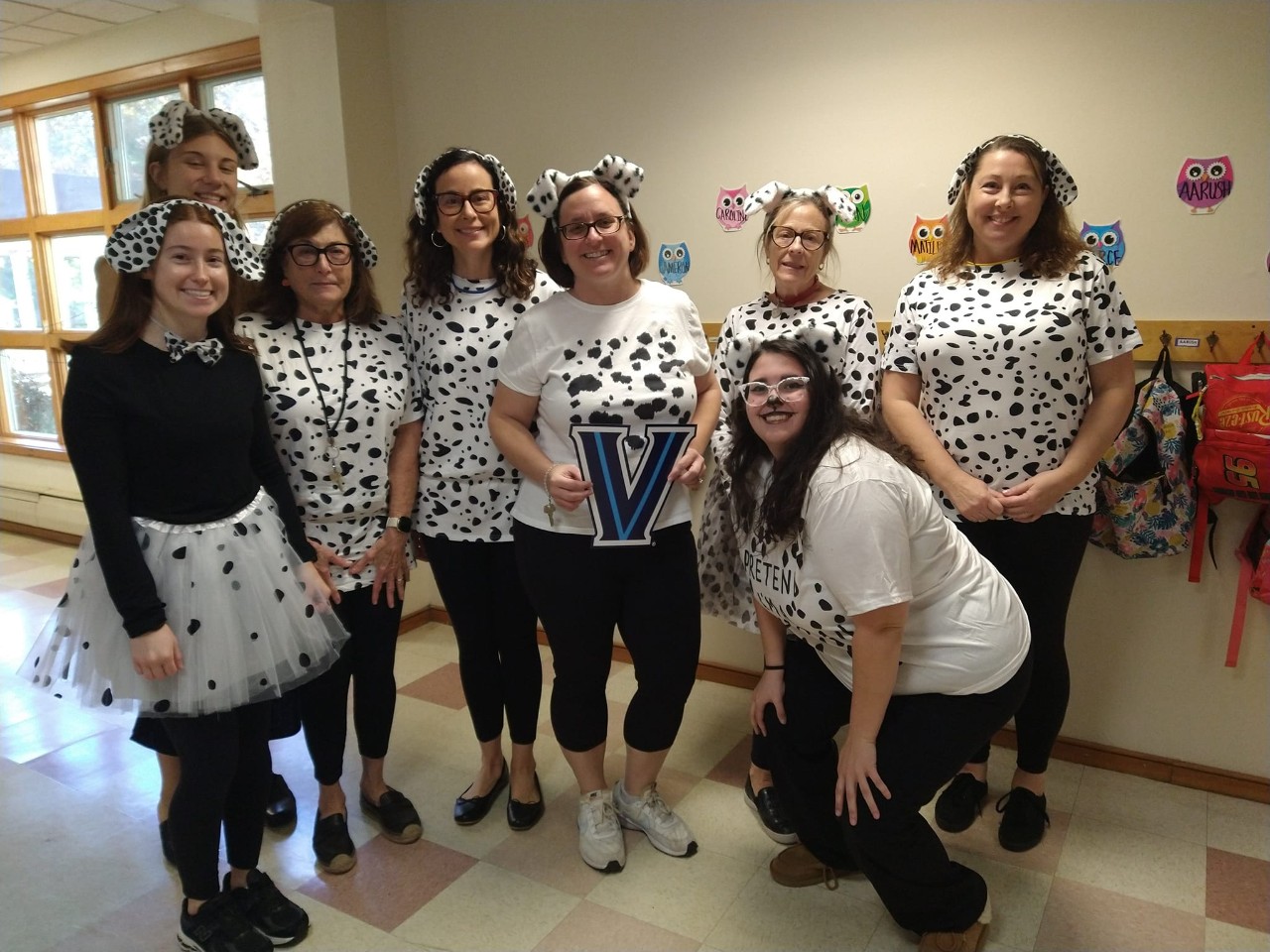 Teachers posing with the Villanova "V"
