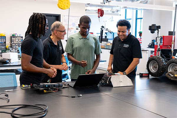 C. Nataraj with graduate students in a lab