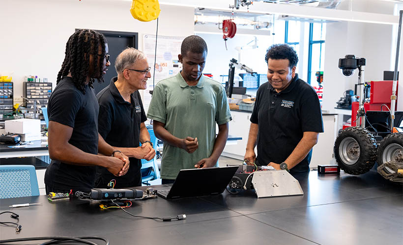 C. Nataraj with graduate students in a lab