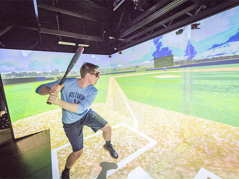A student in a baseball simulator