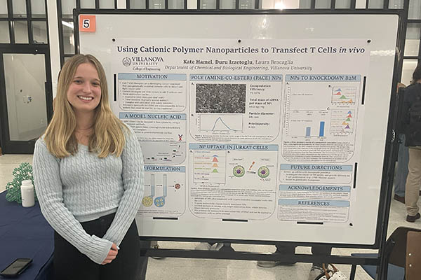 Kate Hamel with a research poster