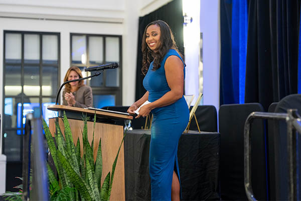 Emberle Pearson giving a speech at an awards banquet
