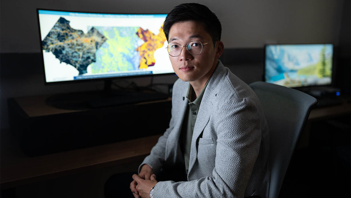 Chenfeng Xiong with a map on a screen
