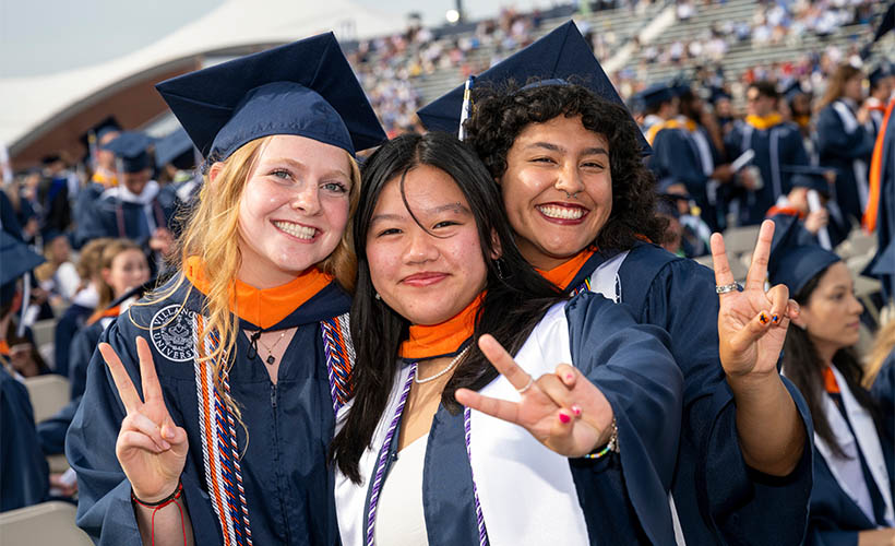 engineering graduates with V's up signs