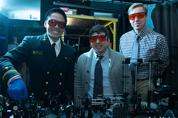 Ronald Warzoha stands with two students in the lab.