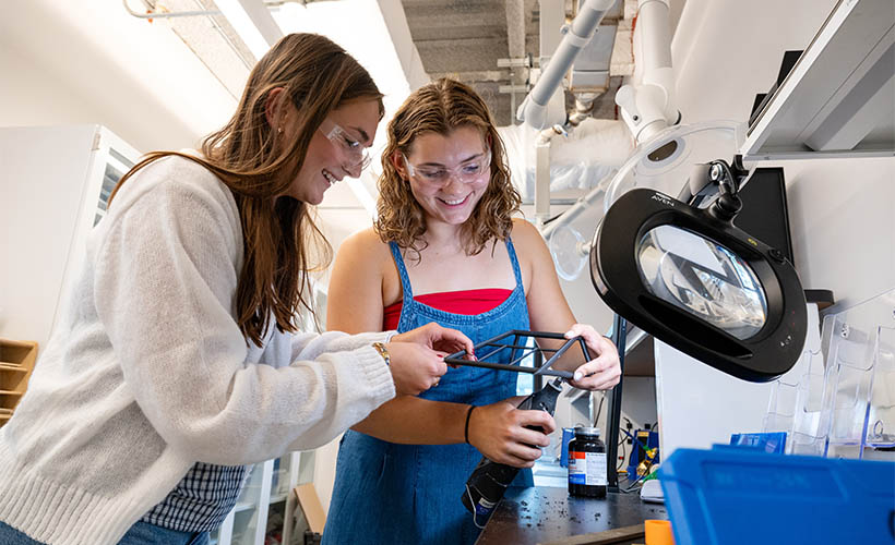 Two female students working in a lab