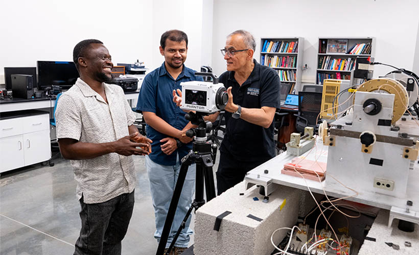 C. Nataraj with graduate students in a lab