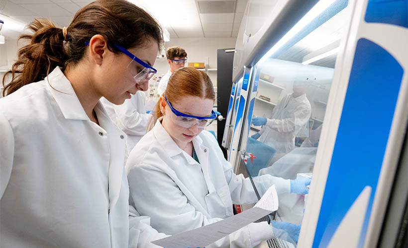 Two female students working in a lab