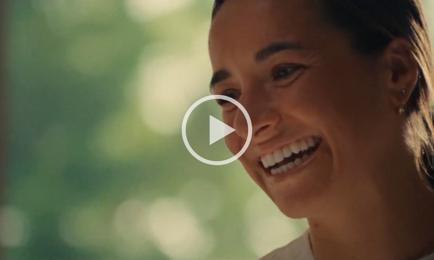 Close up shot of a woman smiling with playhead graphic