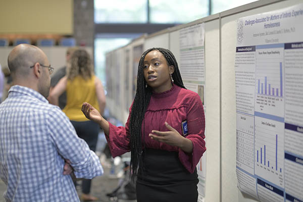 Student presenting her poster at Villanova's Research Symposium.