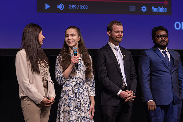 graduate students standing on a stage