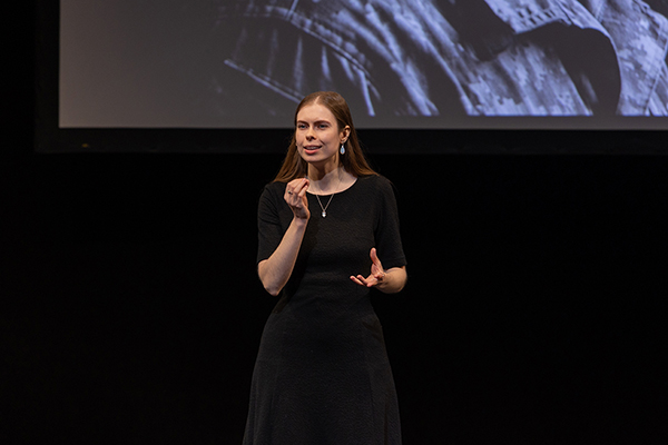 graduate student on stage giving a presentation