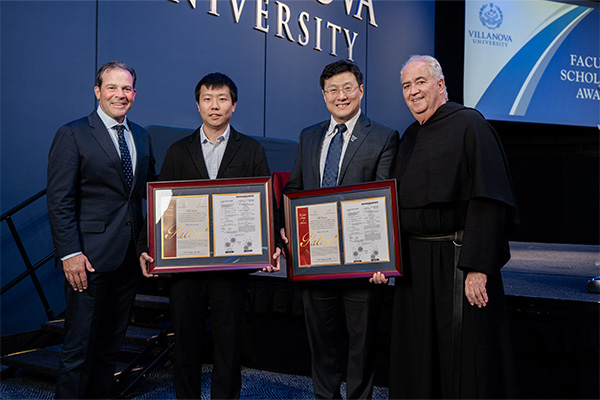 Professor and graduate student receiving awards