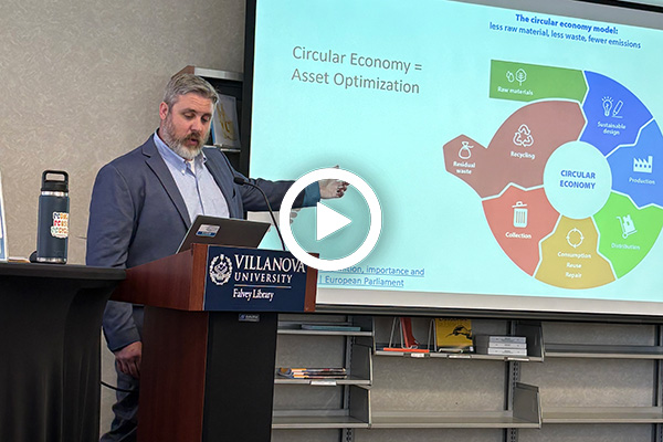 Albert Motel giving his presentation in front of a screen