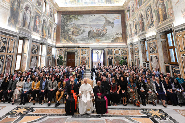 Our Common Home conference attendees sitting with Pope Leo