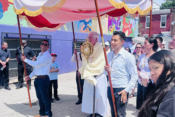 Father John Lydon, OSA, leading a Corpus Christi procession