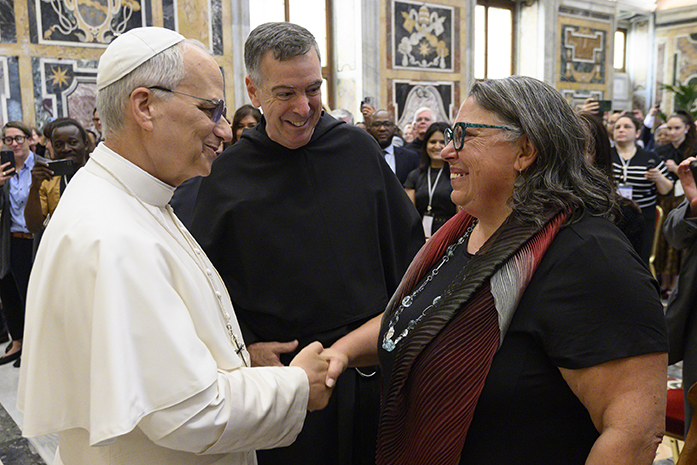 Pope Leo shaking hands with Michele Pistone, Mother Cabrini Institute Faculty Director