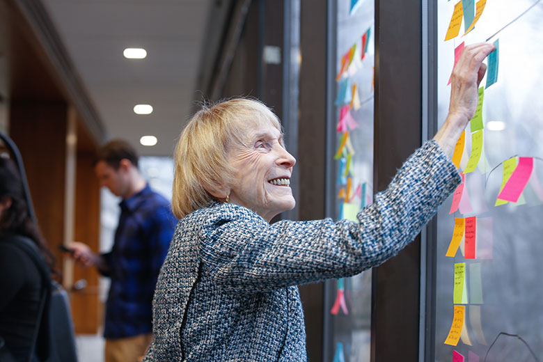 Woman posting a note on a window