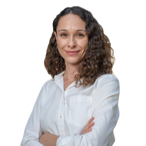 A woman in a white blouse smiles with her arms crossed against a white background.
