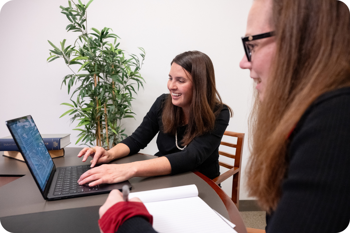 Students smiling at laptop