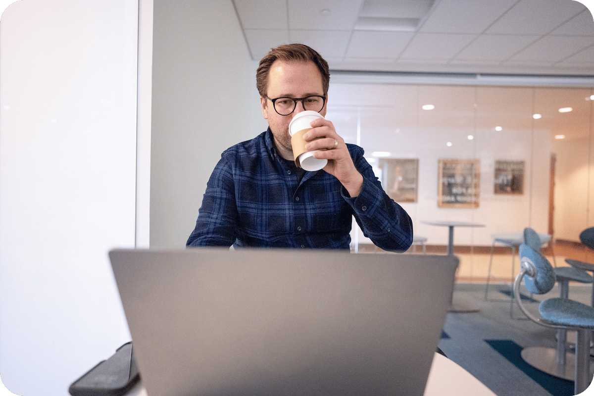 Man with coffee at laptop