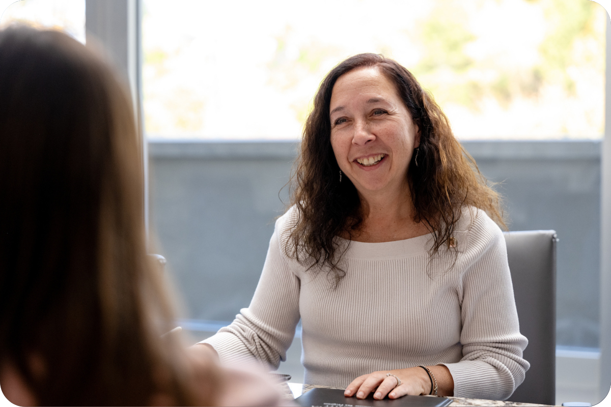 woman smiling at table