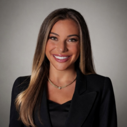 Headshot of a woman in a black blazer against a gray background