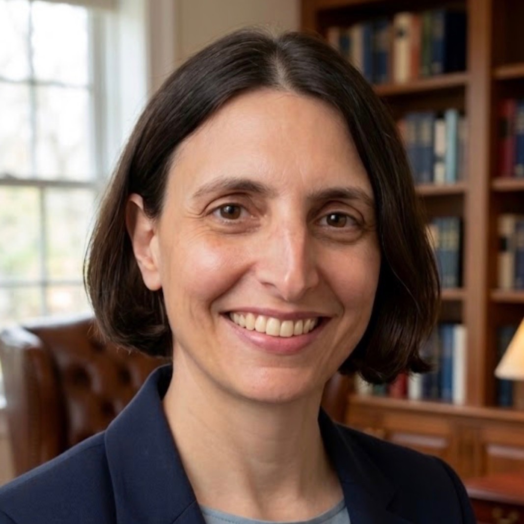 Professional headshot Irina Manta, visiting professor, in an office setting with bookshelves in the background