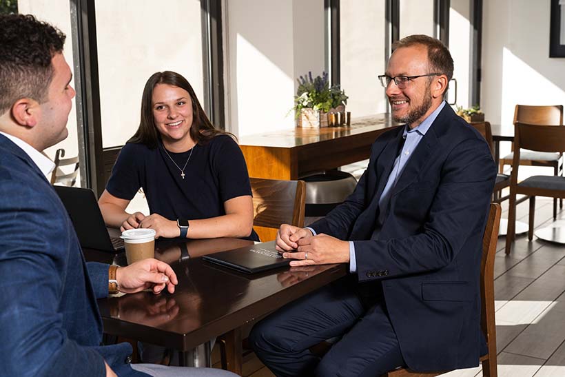 Three student studying in cafe