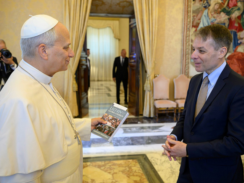 Pope Leo XIV holding the book, "Leo XIV and the Global Church," and Massimo Faggioli, PhD. Photo credit: Vatican Media