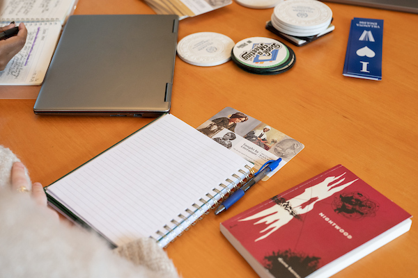 A student's notebook and English text book sit on a desk.