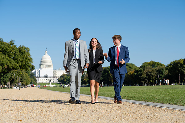 Three Villanova students walking in front of Capitol Hill